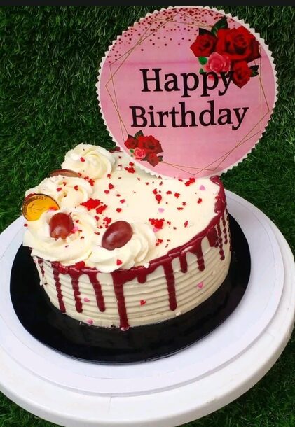 Red velvet drip cake with cream rosettes and a Happy Birthday topper